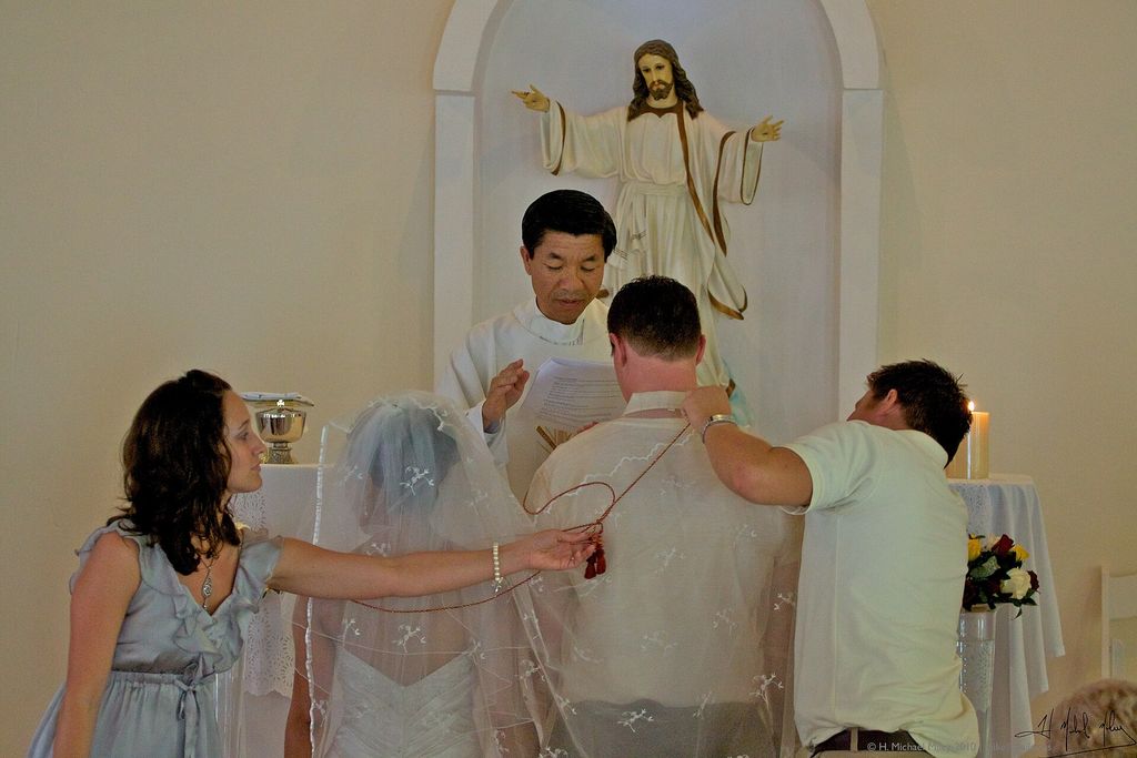 A couple during a Catholic wedding cord ceremony