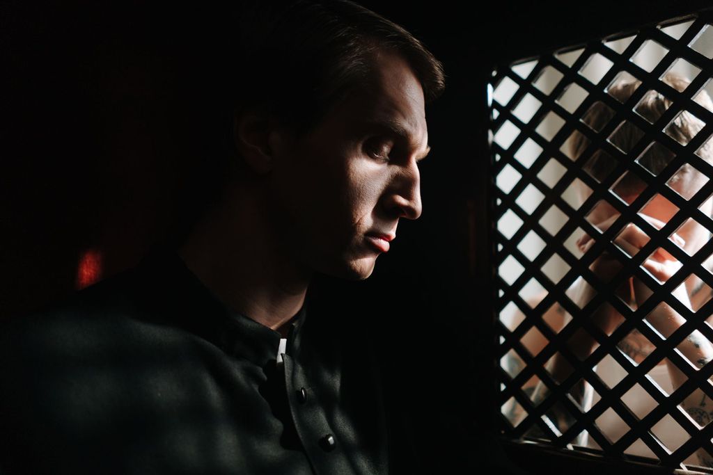 A priest waiting in the confessional