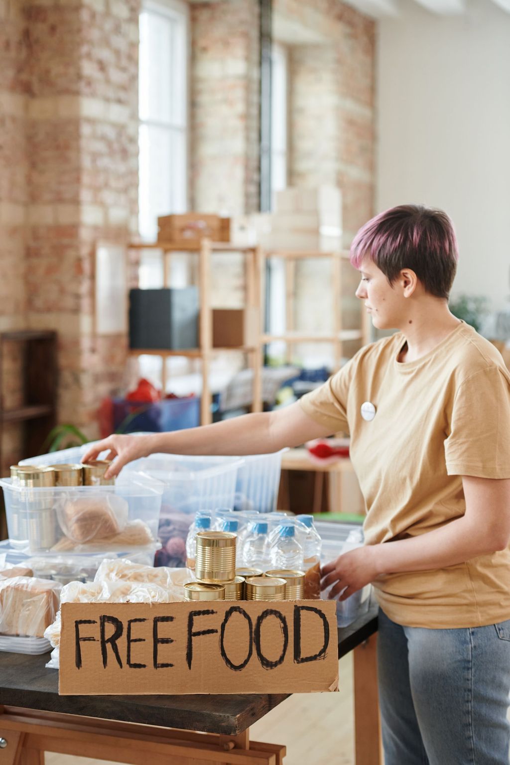 A volunteer at a free food table