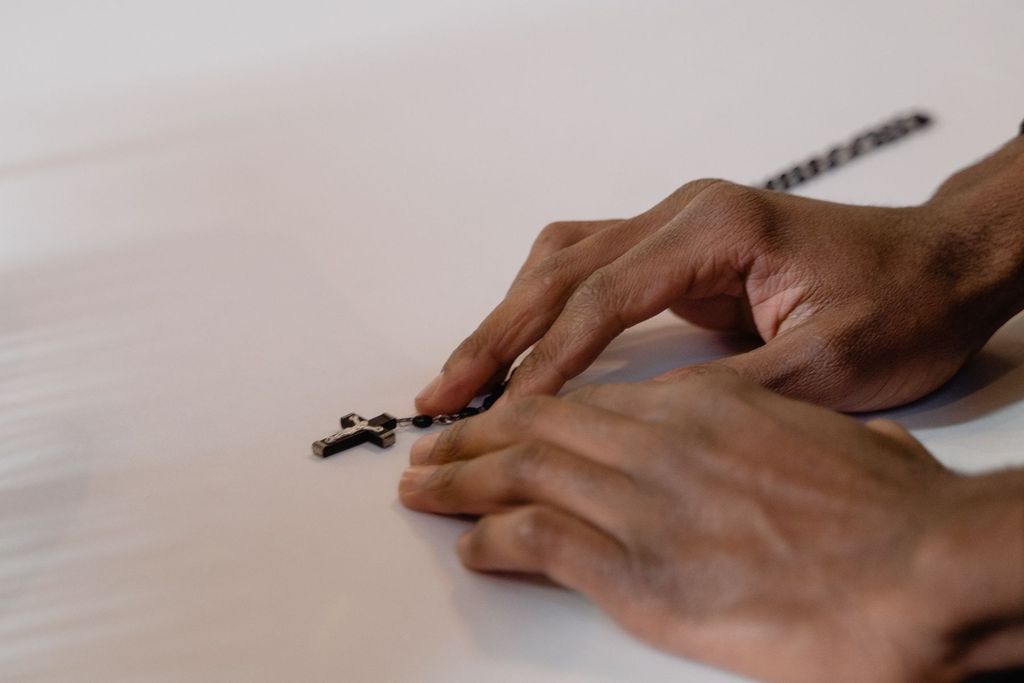 Hands holding a rosary