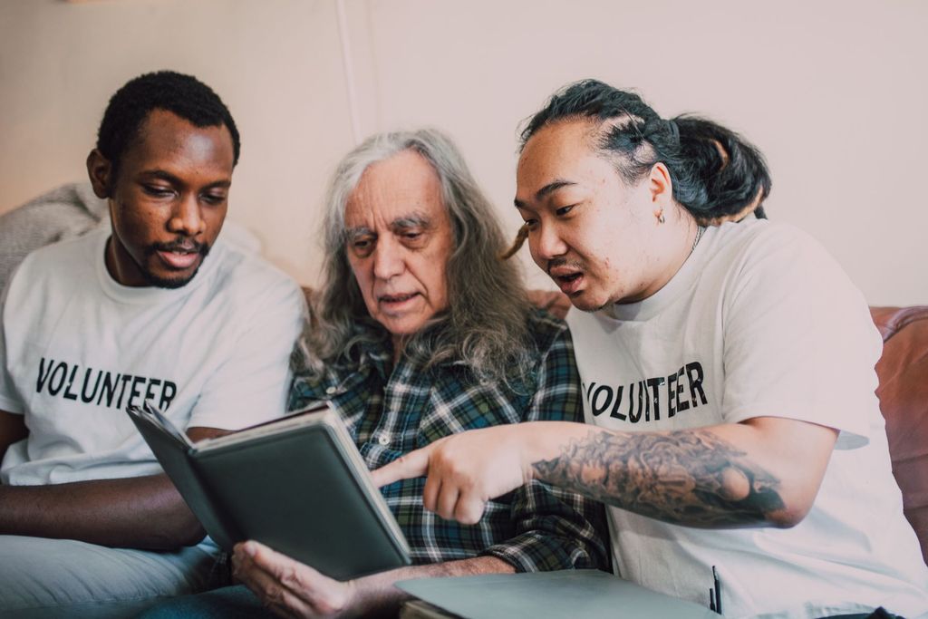 Volunteers visiting an elderly man at home