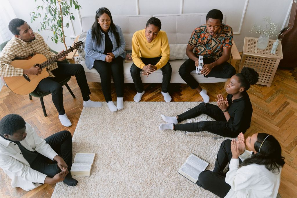 Young adults singing with a guitar